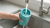 Mivella PawClean being rinsed under running water in a sink